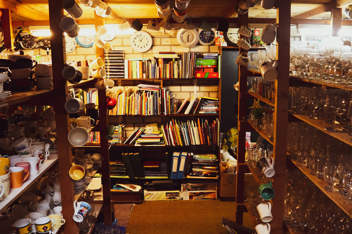 A lot of mugs on a shelf in a store.